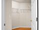 Walk-in closet featuring wood floor, white walls, doorway view of a bathroom and shelving units at 8800 Dorchester Rd # 2004, North Charleston, SC 29420