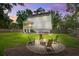 Backyard featuring a fire pit, outdoor seating, and a lush green lawn at 914 Dill Ave, Charleston, SC 29412