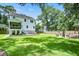Large backyard with a seating area on a deck and a lush green lawn at 914 Dill Ave, Charleston, SC 29412