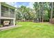 Spacious backyard with lush lawn, trampoline, screened porch and wooden fence at 914 Dill Ave, Charleston, SC 29412