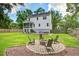 A backyard featuring a fire pit and outdoor seating, set against a lush green lawn at 914 Dill Ave, Charleston, SC 29412