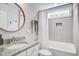 Modern bathroom with granite countertop, round mirror, and tiled shower and bathtub at 914 Dill Ave, Charleston, SC 29412
