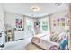 Bright bedroom features carpeted floors, white walls, two windows, and fun decor at 914 Dill Ave, Charleston, SC 29412