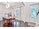 Bright dining room with wood table set, modern chandelier, and natural light from the window at 914 Dill Ave, Charleston, SC 29412