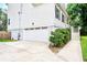 Side of home view, featuring a white garage door and manicured landscaping at 914 Dill Ave, Charleston, SC 29412