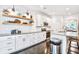 Modern kitchen with white cabinets, subway tile backsplash, and open shelving at 914 Dill Ave, Charleston, SC 29412