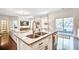 Kitchen island with granite countertop, stainless steel faucet, and open layout to living area at 914 Dill Ave, Charleston, SC 29412