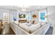 Spacious living room featuring hardwood floors, a modern sofa, and large windows with natural light at 914 Dill Ave, Charleston, SC 29412