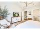 Comfortable main bedroom with a TV on a dresser, white walls, and a decorative light fixture at 914 Dill Ave, Charleston, SC 29412