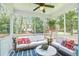 Screened in porch features comfortable white couches and wooded views at 914 Dill Ave, Charleston, SC 29412