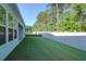 A spacious, well-maintained backyard with lush green grass and a white fence, perfect for outdoor activities at 1009 Field Sparrow Dr # Cc3-2-6, Ravenel, SC 29470