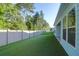 A spacious, well-maintained backyard with lush green grass and a white fence, perfect for outdoor activities at 1009 Field Sparrow Dr # Cc3-2-6, Ravenel, SC 29470