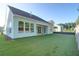 View of the home's backyard featuring lush green lawn and exterior of the home, perfect for relaxation at 1009 Field Sparrow Dr # Cc3-2-6, Ravenel, SC 29470