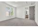 Bright, carpeted bedroom with ample natural light through large windows and a glimpse of the adjacent bathroom at 1009 Field Sparrow Dr # Cc3-2-6, Ravenel, SC 29470