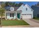 Charming, light blue single-Gathering home with a well-maintained lawn and a bright turquoise front door at 1009 Field Sparrow Dr # Cc3-2-6, Ravenel, SC 29470