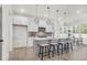 Modern kitchen features a large island with seating, pendant lights, and stainless steel appliances at 1009 Field Sparrow Dr # Cc3-2-6, Ravenel, SC 29470