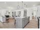 Open concept living space with kitchen island, living room seating, fireplace, and view to the stairwell at 1009 Field Sparrow Dr # Cc3-2-6, Ravenel, SC 29470