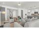 Open concept living space with living room seating, stairwell, and views of the modern kitchen at 1009 Field Sparrow Dr # Cc3-2-6, Ravenel, SC 29470