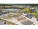 An aerial view showcases the community amenities, a sprawling garden, pool, and a picturesque lake surrounded by houses at 105 Philips Park St, Summerville, SC 29486