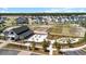 Aerial view of a community farmhouse, community gardens, and agricultural fields at 105 Philips Park St, Summerville, SC 29486