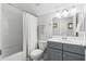 Bathroom with a gray vanity, shower and tub combination, and white toilet at 105 Philips Park St, Summerville, SC 29486