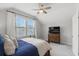 Well-lit bedroom with a large window, comfortable bed, and a dresser with a television at 105 Philips Park St, Summerville, SC 29486