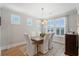 Inviting dining room with natural light, wooden table, stylish chairs, and rug at 105 Philips Park St, Summerville, SC 29486