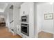 Conveniently located stainless steel double oven and pantry in the bright white kitchen at 105 Philips Park St, Summerville, SC 29486