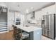 Gourmet kitchen has stainless steel appliances, a large island, and white cabinetry at 105 Philips Park St, Summerville, SC 29486