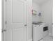 Clean, white laundry room featuring a washer and dryer with a shelf at 105 Philips Park St, Summerville, SC 29486