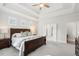 Spacious primary bedroom featuring tray ceilings, a large bed, and dual closets at 105 Philips Park St, Summerville, SC 29486