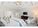 Bright bedroom with a tray ceiling, tv, a sitting area, and doorway to main bathroom at 105 Philips Park St, Summerville, SC 29486