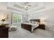 Serene main bedroom features tray ceiling, plantation shutters, and a cozy sitting area at 105 Philips Park St, Summerville, SC 29486