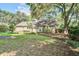 Large backyard with mature trees surrounding the home at 1052 Yorktown Dr, Charleston, SC 29412