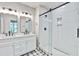 Bathroom showcasing a double vanity with a sleek glass shower with white tiling at 1052 Yorktown Dr, Charleston, SC 29412