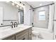 Updated bathroom with marble countertop vanity, hexagon tile, and tub with shower at 1052 Yorktown Dr, Charleston, SC 29412