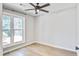 Comfortable bedroom featuring wood floors, a large window, and a ceiling fan at 1052 Yorktown Dr, Charleston, SC 29412