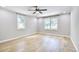 Well-lit bedroom with light wood floors, ceiling fan, and a double window at 1052 Yorktown Dr, Charleston, SC 29412