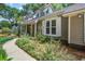 Charming home exterior with walkway, showing manicured garden and traditional siding at 1052 Yorktown Dr, Charleston, SC 29412