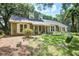 Charming home exterior featuring dormer windows, shutters, manicured landscaping, and a tire swing at 1052 Yorktown Dr, Charleston, SC 29412