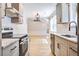 Kitchen with stainless steel appliances, white cabinets, and hardwood floors leading to living room at 1052 Yorktown Dr, Charleston, SC 29412
