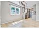 Open living room and kitchen with hardwood floors and natural light from large windows at 1052 Yorktown Dr, Charleston, SC 29412