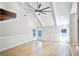 Bright living room featuring vaulted ceilings, modern ceiling fan, and stylish wainscoting details at 1052 Yorktown Dr, Charleston, SC 29412