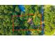 Aerial view of a wooded lot featuring a charming single-Gathering home with mature trees and a generous yard at 107 Joes Ln, Summerville, SC 29486
