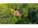 Aerial view showcases the roof of the home surrounded by lush greenery, providing a private, wooded setting at 107 Joes Ln, Summerville, SC 29486