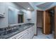 Bathroom with double sinks, gray granite countertop, and decorative wood door at 107 Joes Ln, Summerville, SC 29486