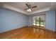 Light-filled bedroom featuring a ceiling fan, hardwood floors, and a large window at 107 Joes Ln, Summerville, SC 29486
