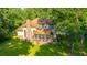 Rear exterior of the home featuring a brick chimney, neutral siding, screened porch, and well-maintained lawn at 107 Joes Ln, Summerville, SC 29486