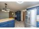 Kitchen with stainless steel refrigerator, blue cabinets, and butcher block countertops at 107 Joes Ln, Summerville, SC 29486