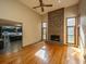 Spacious living room featuring wood floors, a brick fireplace, and natural light at 107 Joes Ln, Summerville, SC 29486